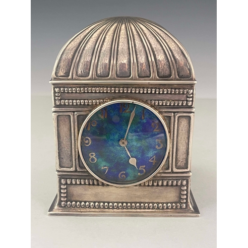 244 - Liberty and Co., an Arts and Crafts silver and enamel timepiece, Birmingham 1910, planished and embo... 