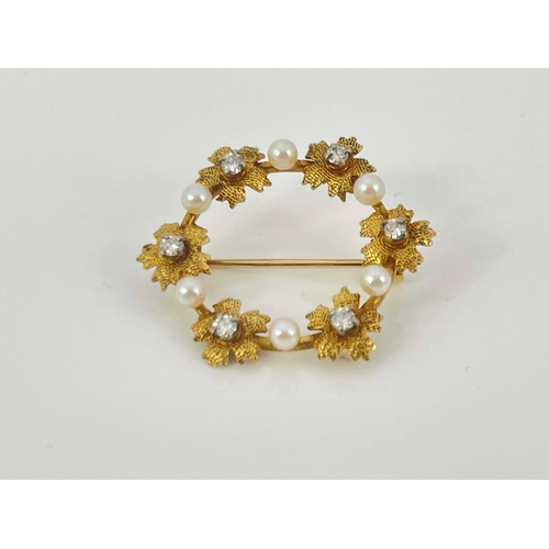 281 - A gold, diamond and pearl wreath brooch, circular form with diamond centred flowers