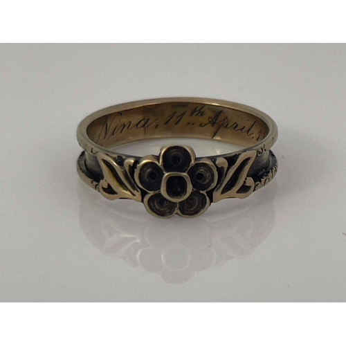 282 - A Victorian gold mourning ring, 1854, the channelled band with central forget me not rosette and lea... 