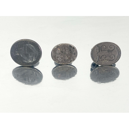 296 - Three Georgian pewter pocket seal fobs, scroll mounts with ring suspension hooks, one with intaglio ... 