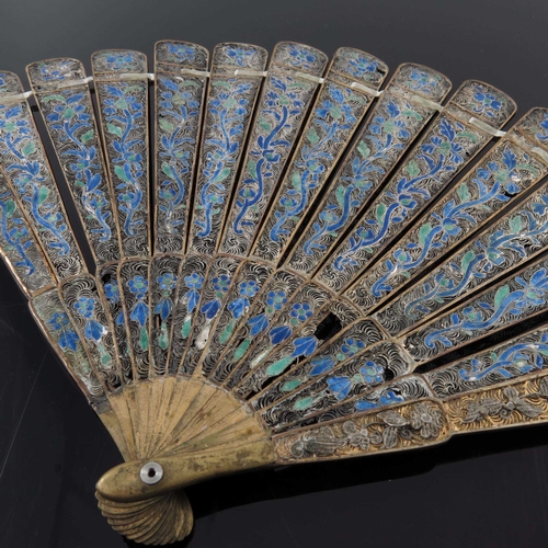 10 - A Chinese gilt filigree and enamelled brise fan, 19th century, the guards with applied floral decora... 