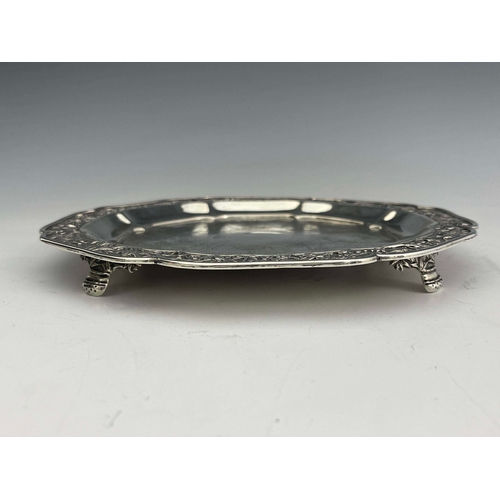 12 - A Chinese silver waiter, lobed octagonal form, chased figural panels and moulded floral and bamboo b... 