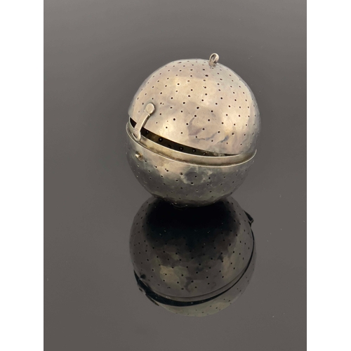 14 - An 18th century white metal pomander or herb infuser, spherical ball form, pierced with holes, hinge... 