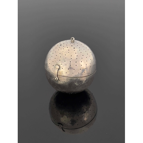 14 - An 18th century white metal pomander or herb infuser, spherical ball form, pierced with holes, hinge... 