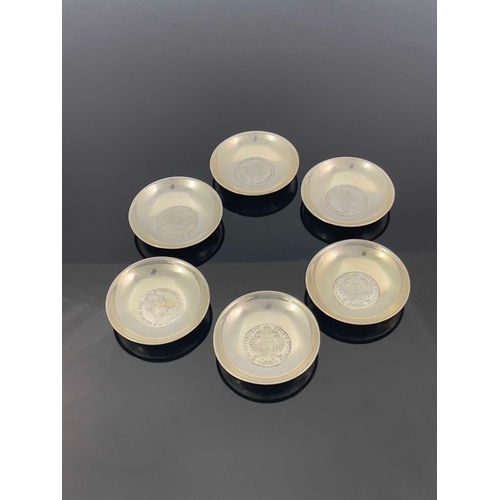 17 - A set of six white metal coin dishes, each set with a 1780 Maria Theresa thaler, 9cm diameter, 15.32... 