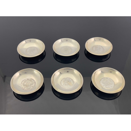 17 - A set of six white metal coin dishes, each set with a 1780 Maria Theresa thaler, 9cm diameter, 15.32... 