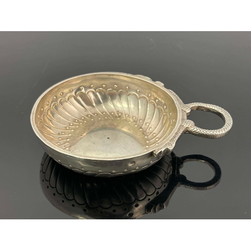 28 - A Late 18th century French silver wine taster, shallow dished circular form with embossed gadrooned ... 