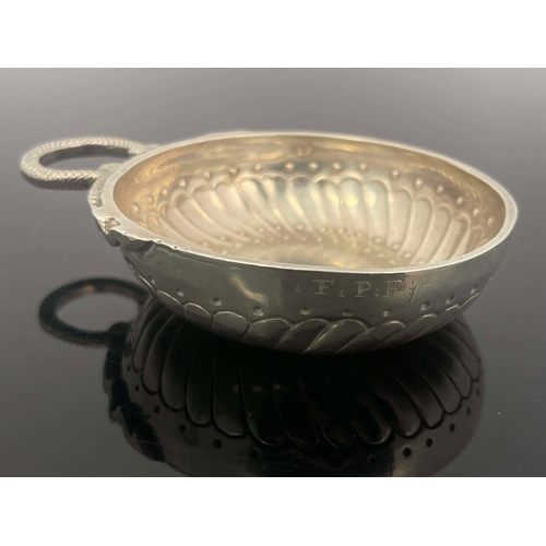 28 - A Late 18th century French silver wine taster, shallow dished circular form with embossed gadrooned ... 