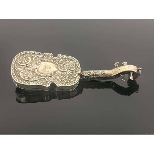 31 - A Continental novelty silver scent flask, 19th century, modelled as a violin, embossed in relief wit... 