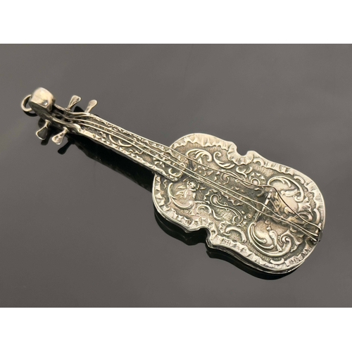 31 - A Continental novelty silver scent flask, 19th century, modelled as a violin, embossed in relief wit... 