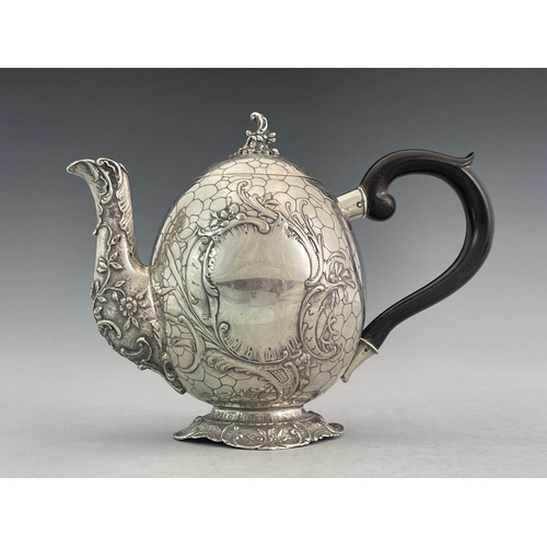 38 - A German silver teapot, GGH, circa 1890, egg form, engraved with pebble design, embossed Rococo foli... 