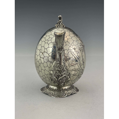 38 - A German silver teapot, GGH, circa 1890, egg form, engraved with pebble design, embossed Rococo foli... 