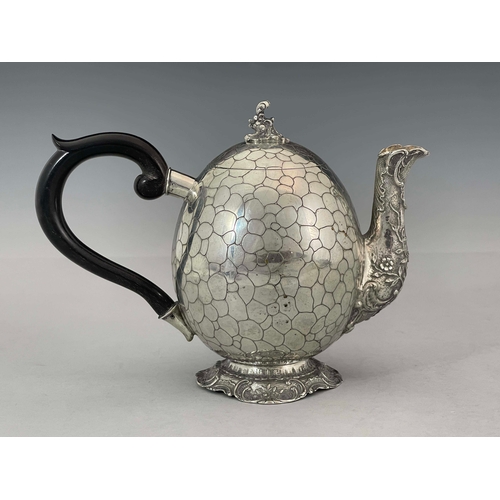 38 - A German silver teapot, GGH, circa 1890, egg form, engraved with pebble design, embossed Rococo foli... 