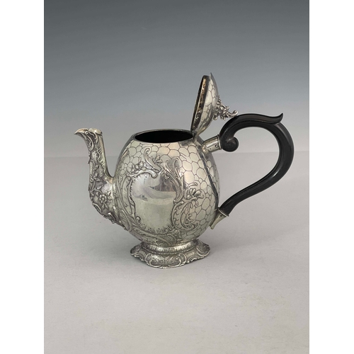 38 - A German silver teapot, GGH, circa 1890, egg form, engraved with pebble design, embossed Rococo foli... 