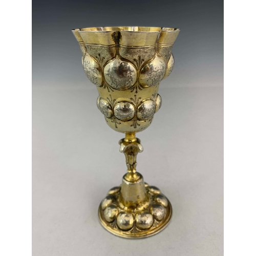 44 - A 17th century German silver gilt chalice cup, HDS, Augsburg circa 1620, the ogee bowl embossed in r... 