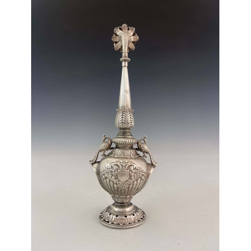 6 - A white metal water sprinkler, twin handled baluster form with elongated faceted spout and pierced f... 