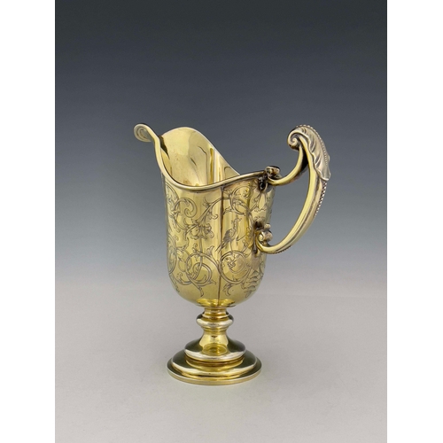 69 - A Victorian silver gilt ewer, Robert Garrard II, London 1841, lobed helmet form on knopped and stepp... 