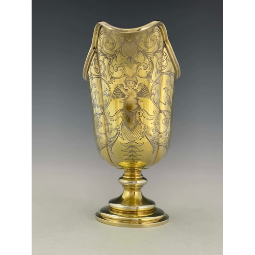 69 - A Victorian silver gilt ewer, Robert Garrard II, London 1841, lobed helmet form on knopped and stepp... 