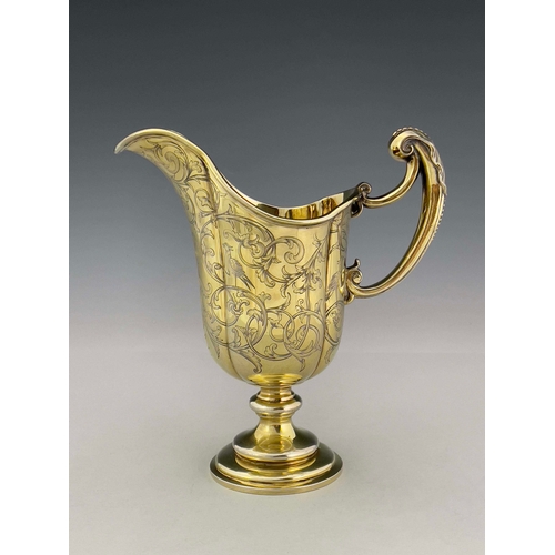 69 - A Victorian silver gilt ewer, Robert Garrard II, London 1841, lobed helmet form on knopped and stepp... 