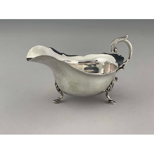 92 - A George V silver sauce boat, Daniel George Collins, Sheffield 1912, helmet form with ogee rim, acan... 