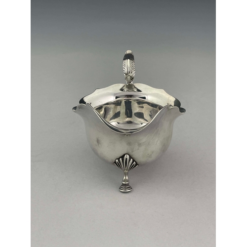 92 - A George V silver sauce boat, Daniel George Collins, Sheffield 1912, helmet form with ogee rim, acan... 