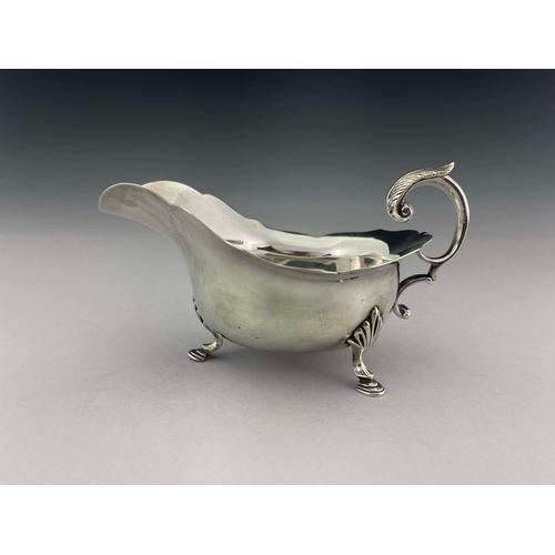 92 - A George V silver sauce boat, Daniel George Collins, Sheffield 1912, helmet form with ogee rim, acan... 