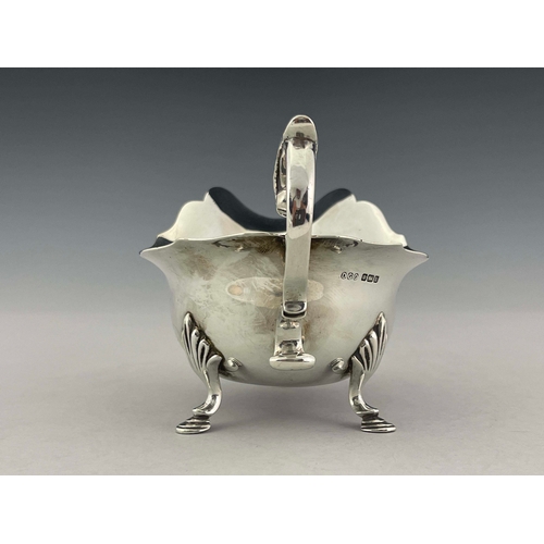 92 - A George V silver sauce boat, Daniel George Collins, Sheffield 1912, helmet form with ogee rim, acan... 