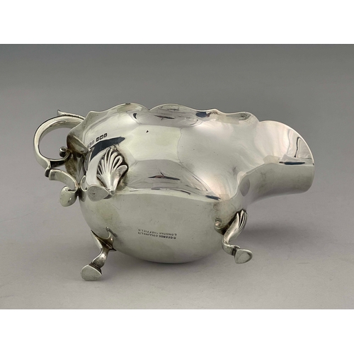 92 - A George V silver sauce boat, Daniel George Collins, Sheffield 1912, helmet form with ogee rim, acan... 