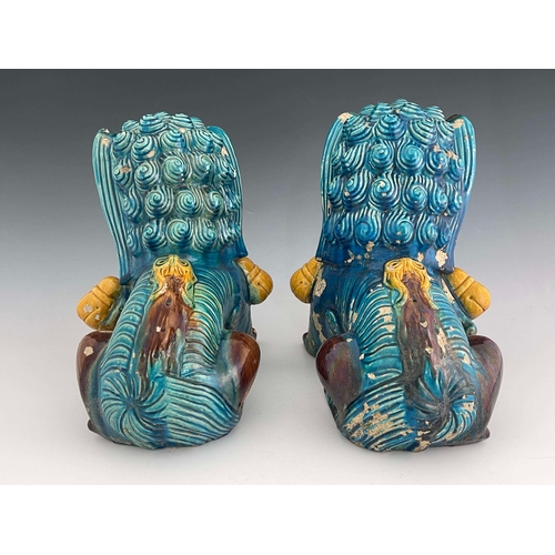 360 - A large pair of Chinese tang glazed foo dogs, circa 1880, modelled sitting, one with paw resting on ... 