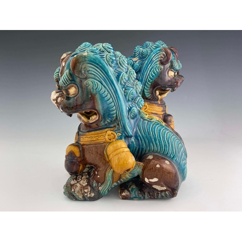 360 - A large pair of Chinese tang glazed foo dogs, circa 1880, modelled sitting, one with paw resting on ... 