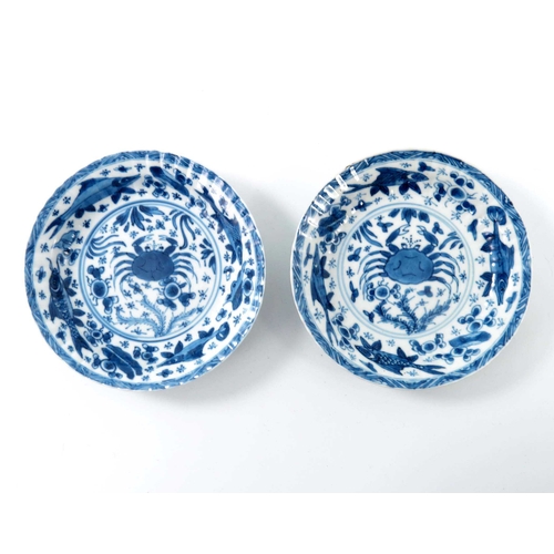 382 - A pair of Chinese blue and white ribbed moulded saucers, kangxi, each painted with a central crab wi... 