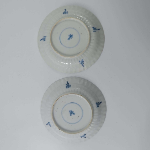 382 - A pair of Chinese blue and white ribbed moulded saucers, kangxi, each painted with a central crab wi... 