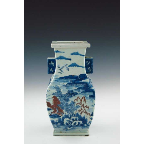 393 - A Chinese provincial blue and white baluster vase, 19th Century, of rectangular section with angular... 