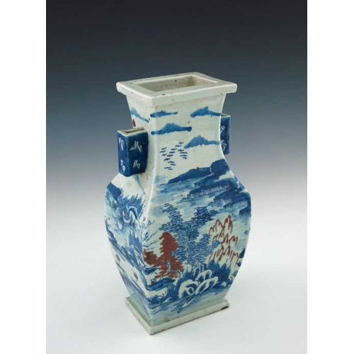 393 - A Chinese provincial blue and white baluster vase, 19th Century, of rectangular section with angular... 