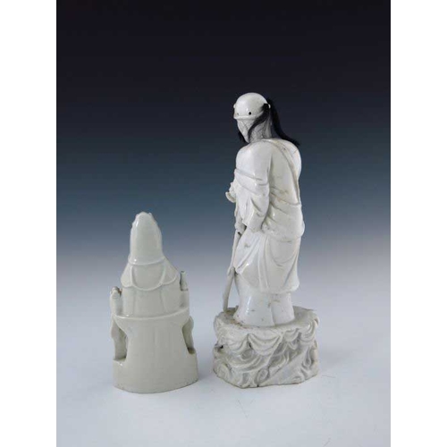 395 - A 19th Century Chinese blanc de chine figure, modelled as a standing elder with a wooden staff, real... 