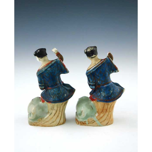 398 - A pair of 18th Century Chinese porcelain figurines, modelled as joyful and playful boys upon a stump... 