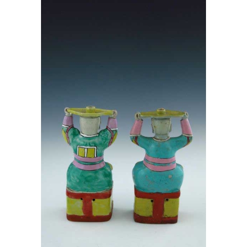 399 - A pair of Chinese coloured enamel porcelain candle holders, in the form of smiling bearded men in ro... 