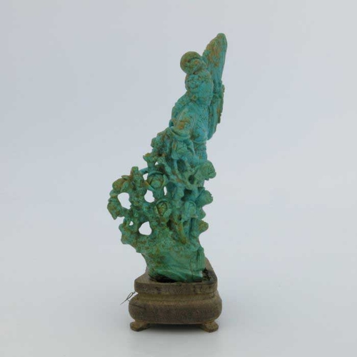 400 - An oriental turquoise figure of a Geisha, modelled standing with a fan beside foliage, 15cm high, wo... 