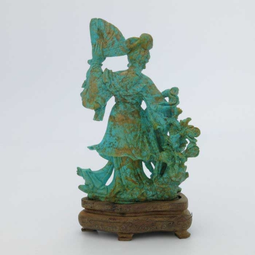 400 - An oriental turquoise figure of a Geisha, modelled standing with a fan beside foliage, 15cm high, wo... 