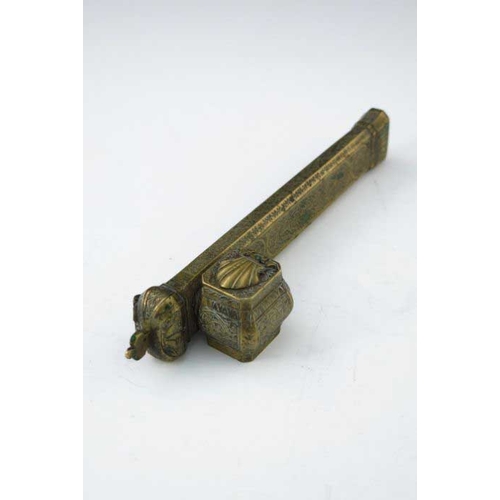 404 - An Islamic brass scribe's inkwell, incorporating quill holder, 23cm long