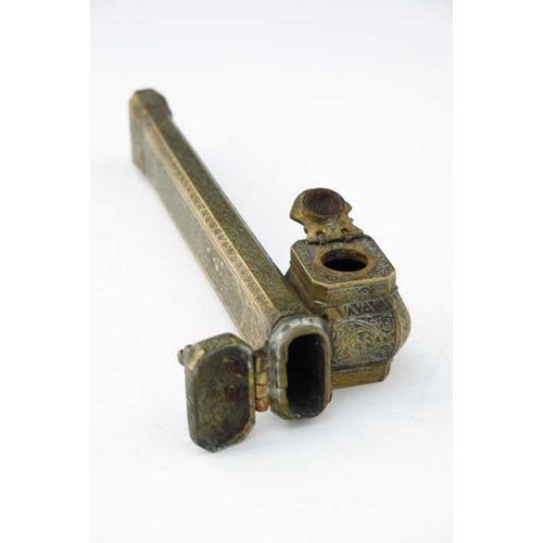 404 - An Islamic brass scribe's inkwell, incorporating quill holder, 23cm long