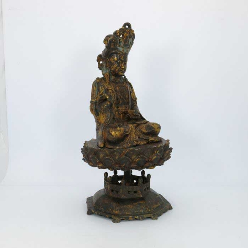 405 - A large Chinese gilt bronze figure of a deity, seated cross legged and wearing a headdress, mounted ... 