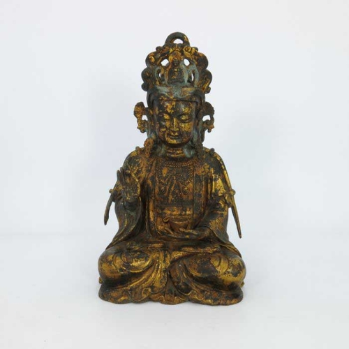 405 - A large Chinese gilt bronze figure of a deity, seated cross legged and wearing a headdress, mounted ... 