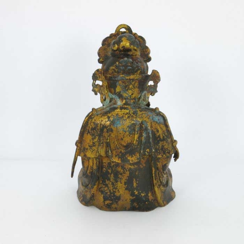 405 - A large Chinese gilt bronze figure of a deity, seated cross legged and wearing a headdress, mounted ... 