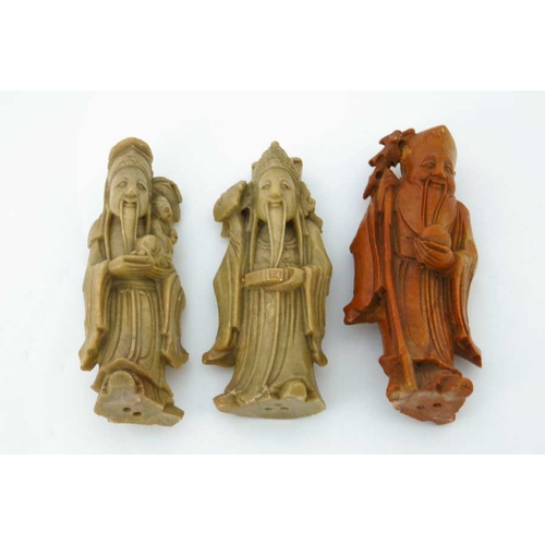 410 - A Chinese soapstone carving, in the form of five robed figures mounted upon a rocky outcrop, 34cm hi... 