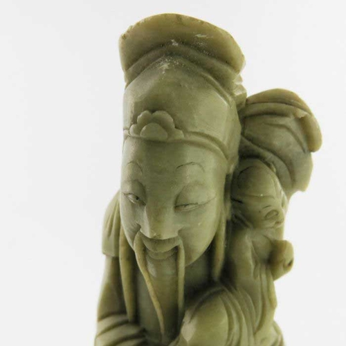 410 - A Chinese soapstone carving, in the form of five robed figures mounted upon a rocky outcrop, 34cm hi... 