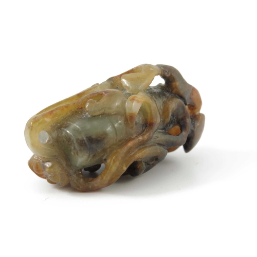 416 - A Chinese jade carving, in the form of a kylin on a rock, russet inclusions, 4.5cm