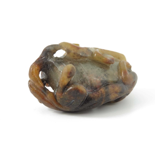 416 - A Chinese jade carving, in the form of a kylin on a rock, russet inclusions, 4.5cm