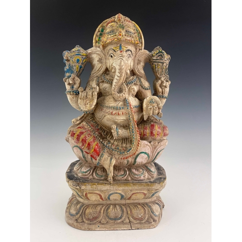 426 - An Indian carved figure of Ganesha, painted in multiple colours on white ground, 38cm high