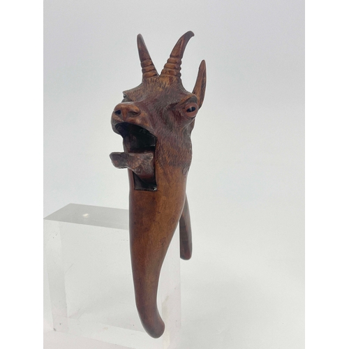 436 - A Black Forest carved wood nut cracker, modelled as a deer, the mouth opening, set with spherical gl... 